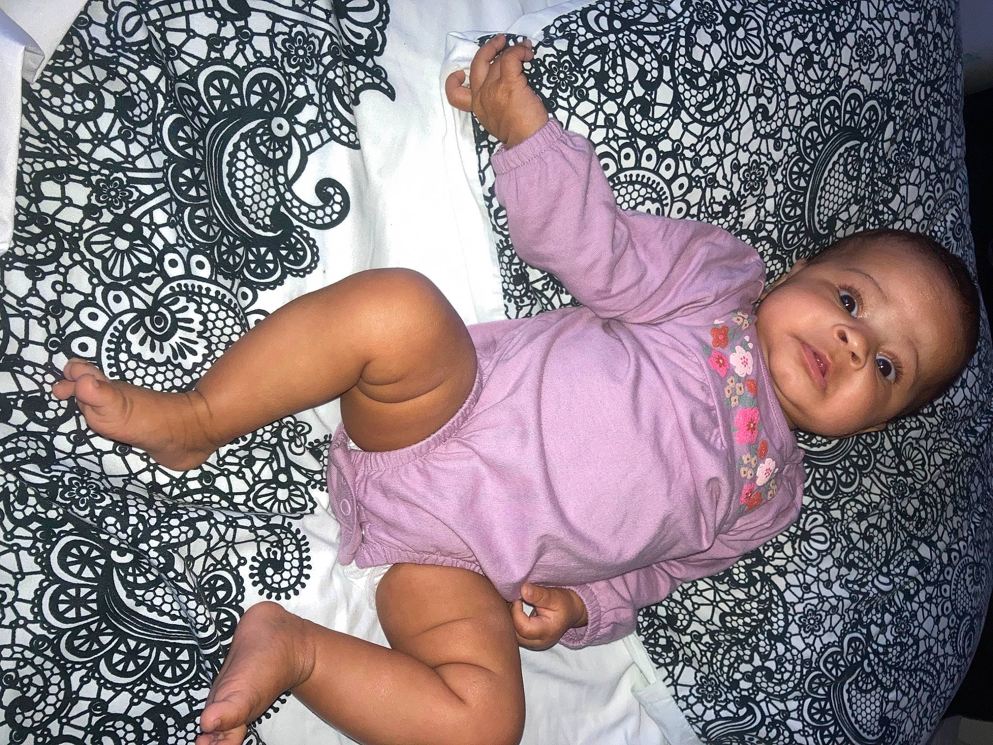 Kaylani is registered to the contest to win money with this photo: art, baby_toddler_clothing, comfort, finger, fun, hairstyle, hand, happy, head, human_body, human_leg, leg, pattern, person, pink, purple, smile, textile, thigh, thumb
