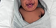 Elijah is registered to the contest to win money with this photo: baby, smiling, towel, wrapped, happy, infant, child, cute, skin, person, portrait, hand, white, fabric, texture, lying, indoors, blanket, cozy, joyful
