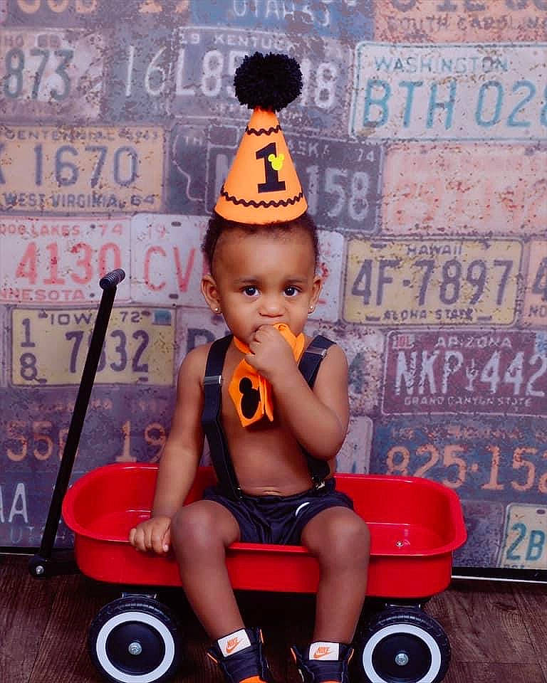 Kentrell joined the competition — help win amazing prizes! black_hair, child, headgear, person, play, sitting, toddler, toy, vehicle