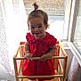 Alba a rejoint le concours — aidez-le/la à gagner de superbes lots ! toddler, child, red_dress, smile, pacifier, wooden_chair, window, curtain, indoors, hair_pony_tail, baby, furniture, person, standing, happy, face, daylight, home, room, playful