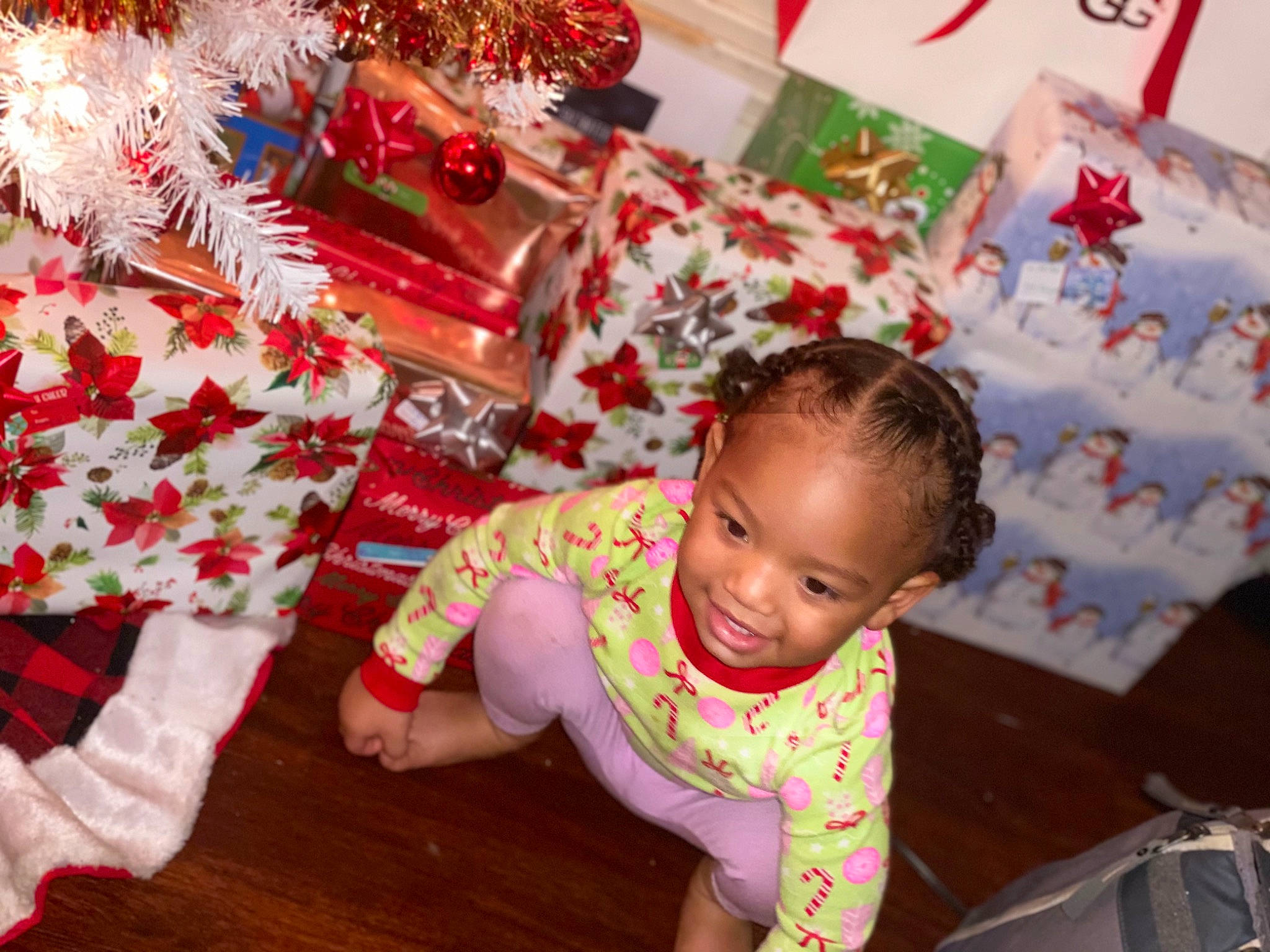 Tamiko is registered to the contest to win money with this photo: baby, baby_toddler_clothing, cheek, child, christmas, christmas_decoration, christmas_eve, christmas_ornament, crawling, eye, floor, flooring, holiday, holiday_ornament, human, interior_design, mouth, nose, person, red