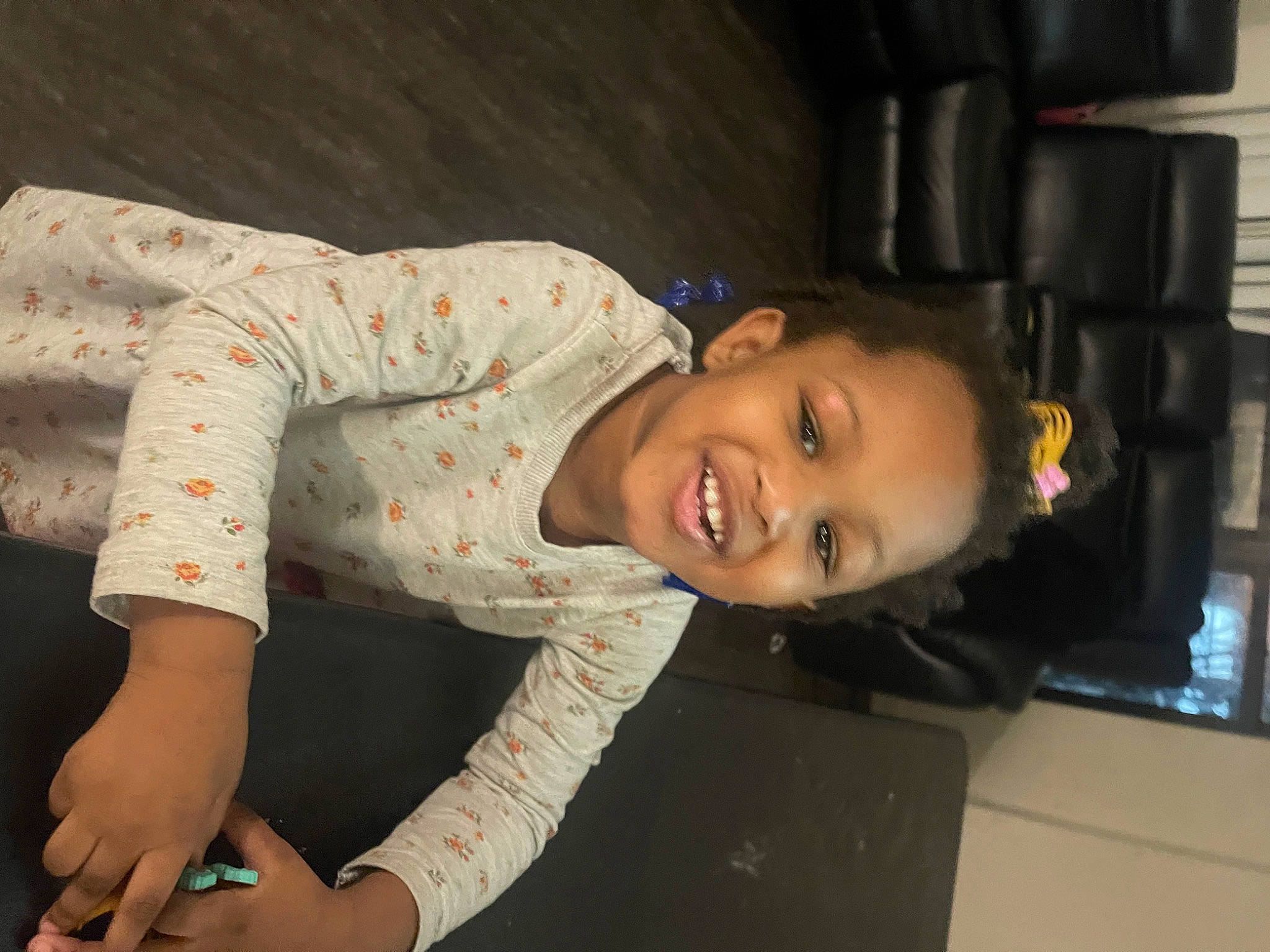 Kayleigh is registered to the contest to win money with this photo: abdomen, chest, child, elbow, face, flash_photography, flesh, fun, happy, human_leg, joy, knee, neck, pattern, person, sitting, sleeve, smile, t_shirt, thigh