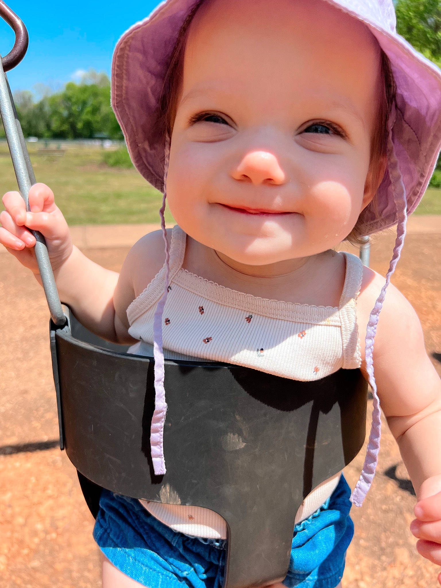 Daisie is registered to the contest to win money with this photo: arm, baby_toddler_clothing, blue, chin, eye, face, facial_expression, finger, gesture, hand, happy, hat, head, joy, lip, person, photograph, pink, skin, sleeve