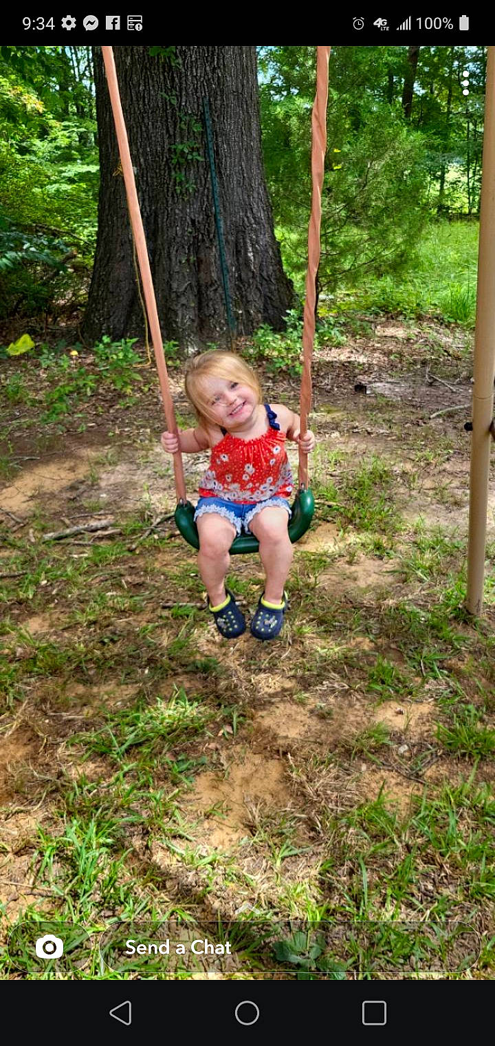 Paisley is registered to the contest to win money with this photo: baby, baby_toddler_clothing, child, fun, grass, happy, joy, jungle, leaf, leisure, outdoor_play_equipment, people_in_nature, person, plant, playground, recreation, shorts, smile, soil, swing