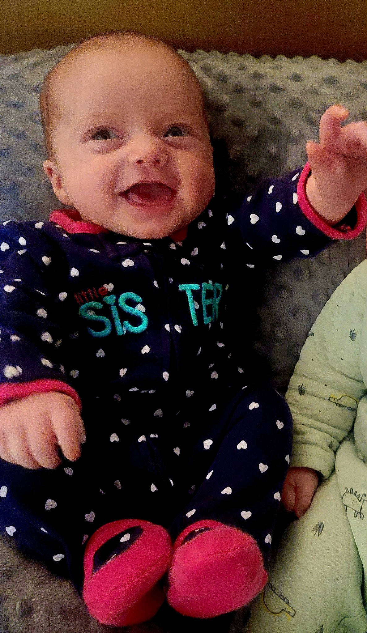 Isla joined the competition — help win amazing prizes! arm, baby, baby_toddler_clothing, cheek, face, facial_expression, finger, gesture, happy, head, human_body, outerwear, person, photograph, pink, product, skin, sleeve, smile, standing