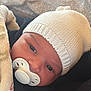 baby, blanket, child, close_up, comfort, cozy, cute, face, hat, headwear, indoors, infant, knitted_hat, newborn, pacifier, person, portrait, sleepy, soft, warm