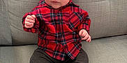 Henry joined the competition — help win amazing prizes! baby, infant, child, plaid_shirt, red_clothing, gray_couch, socks, sitting, indoors, cute, portrait, young_child, comfortable, casual_clothing, small_hands, curly_hair, expression, face, person, cozy