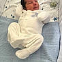 Henry is registered to the contest to win money with this photo: newborn, baby, infant, onesie, blanket, blue, white, sleepwear, pacifier, stars, knitted, bed, sleeping, cute, soft, cozy, face, lying_down, indoors, child