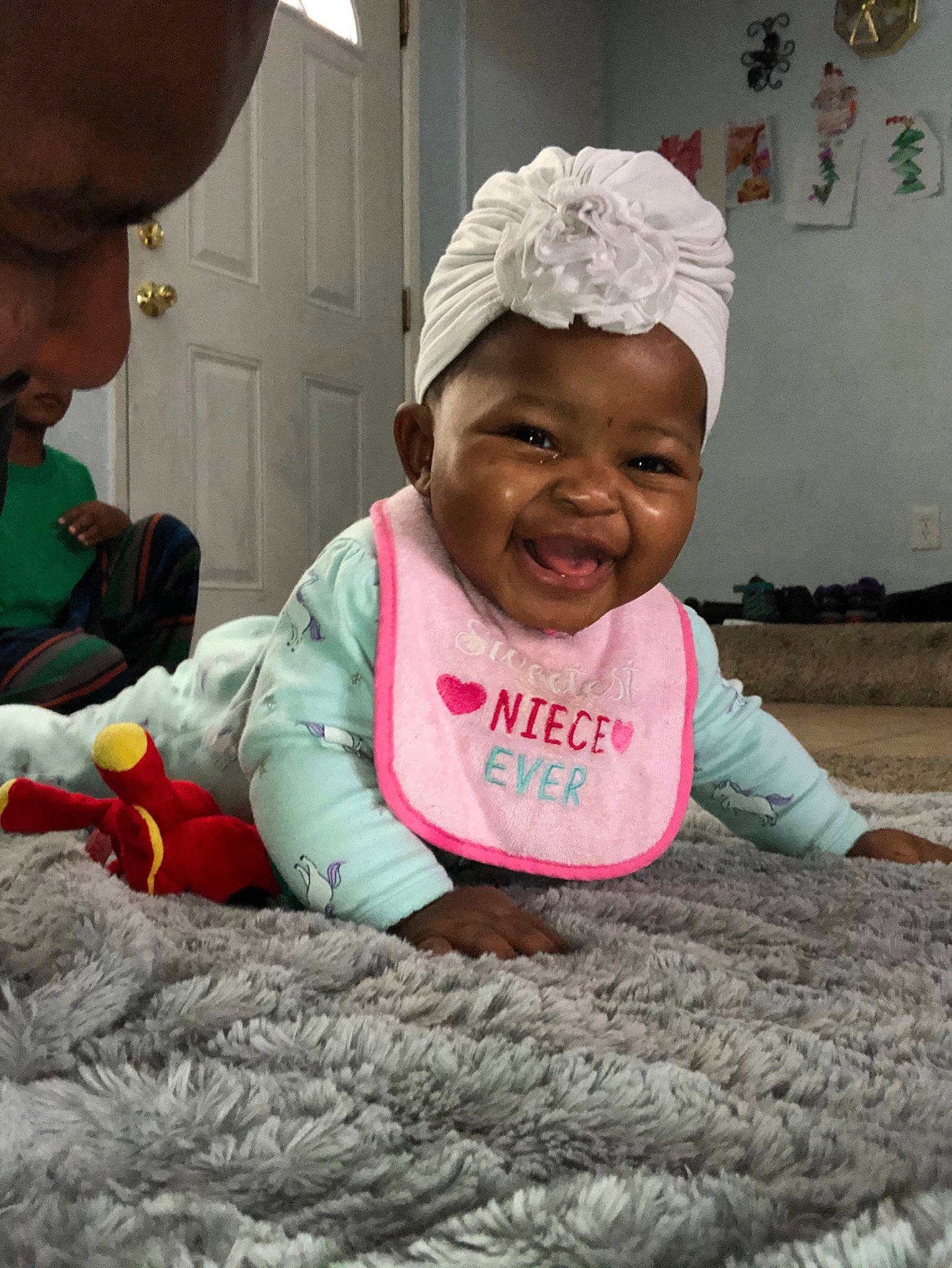 Merci is registered to the contest to win money with this photo: adaptation, baby, child, happy, headgear, headwear, person, play, sitting, smile, toddler