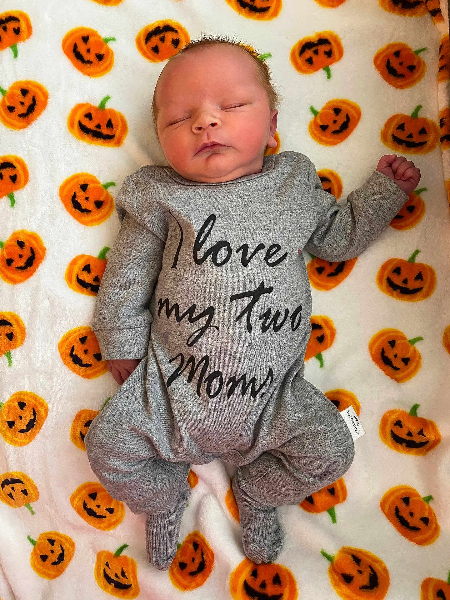 Bowdee is registered to the contest to win money with this photo: baby, newborn, sleeping, onesie, clothing, grey, blanket, pumpkin, jack_o_lantern, orange, white, infant, cute, peaceful, lying_down, child, portrait, festive, halloween, soft