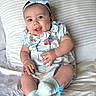 baby, blanket, bracelet, child, comfort, cushion, cute, dress, footwear, happy, headband, indoors, infant, person, portrait, sitting, small_hands, smiling, sock, soft_toys