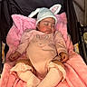baby, sleeping, pink_blanket, bunny_ears_hat, stroller, cute_outfit, infant, soft_texture, cozy, child, peaceful, newborn, sock, pink_clothing, adorable, resting, portrait, baby_girl, hat, toddler