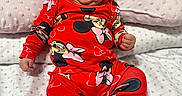 Iliany Diaz joined the competition — help win amazing prizes! baby, infant, child, red_clothing, minnie_mouse, headband, smile, bed, pillow, blanket, cute, indoors, person, sitting, happy, face, chubby_cheeks, patterned_clothing, soft_lighting, portrait