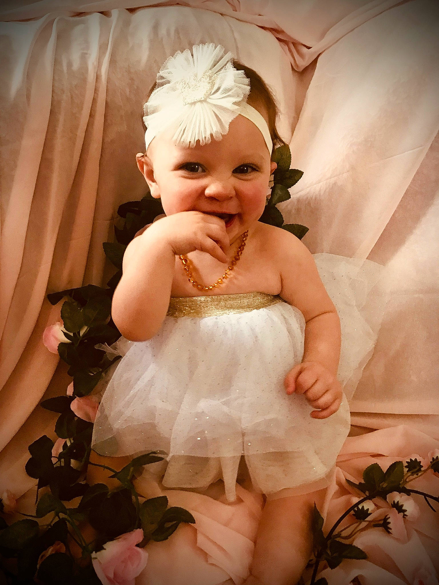 Charlotte is registered to the contest to win money with this photo: arm, baby_toddler_clothing, day_dress, dress, embellishment, flash_photography, gesture, hand, happy, head, headgear, headpiece, iris, joy, person, petal, pink, skin, smile, textile