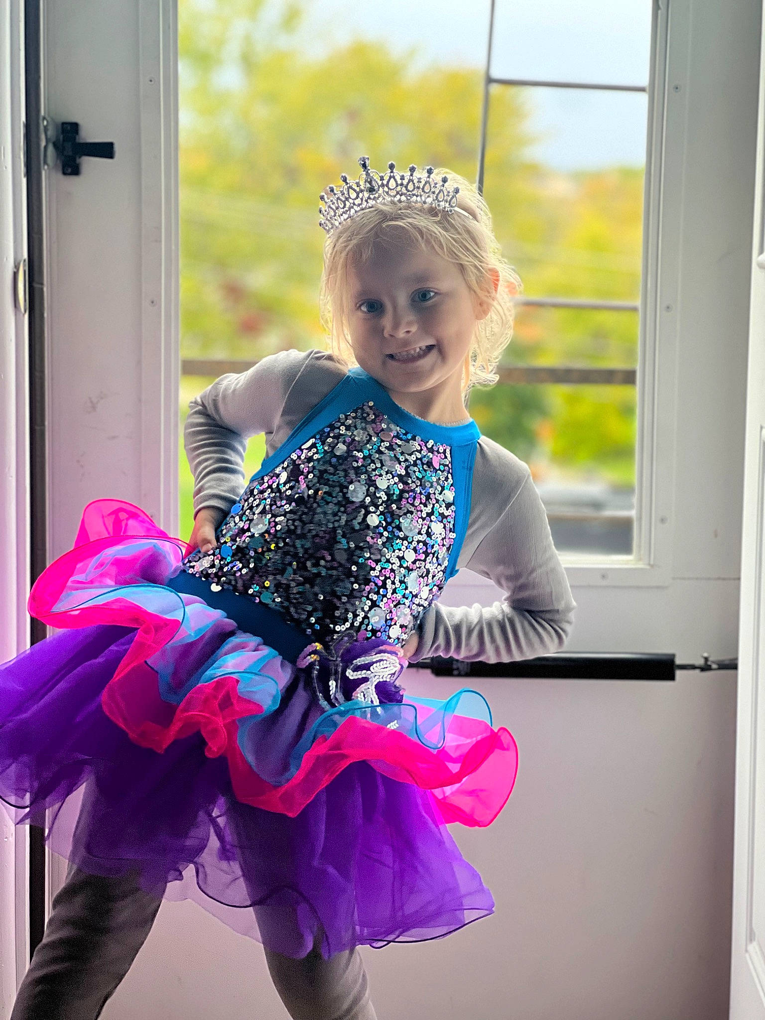 Katerina is registered to the contest to win money with this photo: baby_toddler_clothing, ballet_tutu, child, costume, day_dress, electric_blue, entertainment, event, fashion_accessory, fun, happy, joy, magenta, person, pink, purple, recreation, ruffle, sitting, smile