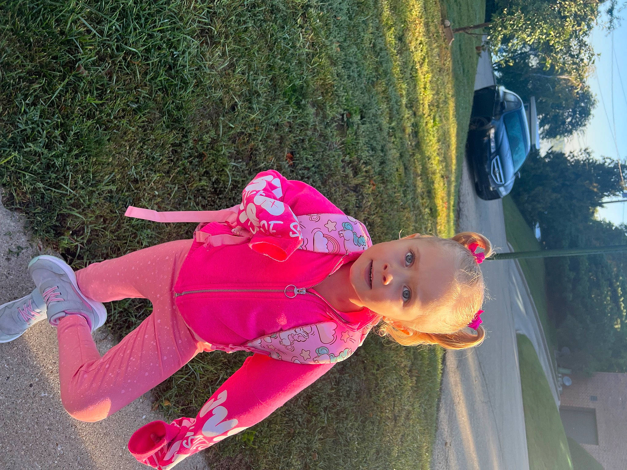 Katerina is registered to the contest to win money with this photo: automotive_lighting, car, carmine, fun, grass, happy, leisure, magenta, person, pink, plant, recreation, sky, tints_and_shades, tire, toddler, tree, vehicle, vehicle_door, wheel