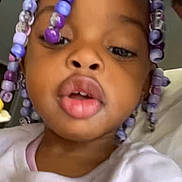 Elanii joined the competition — help win amazing prizes! child, face, beads, hair, video_call, screen, hoodie, smile, indoor, casual_clothing, portrait, young_child, closeup, person, technology, communication, digital_screen, expression, multigenerational, interaction