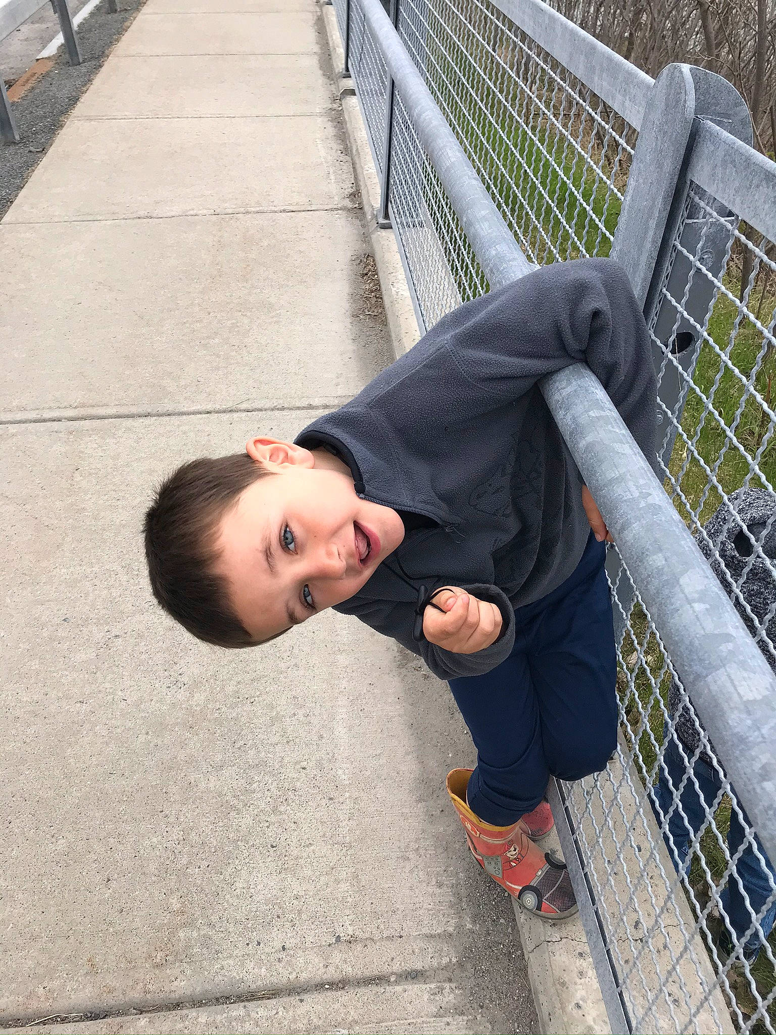 Julien is registered to the contest to win money with this photo: child, guard_rail, handrail, person, sitting, vacation