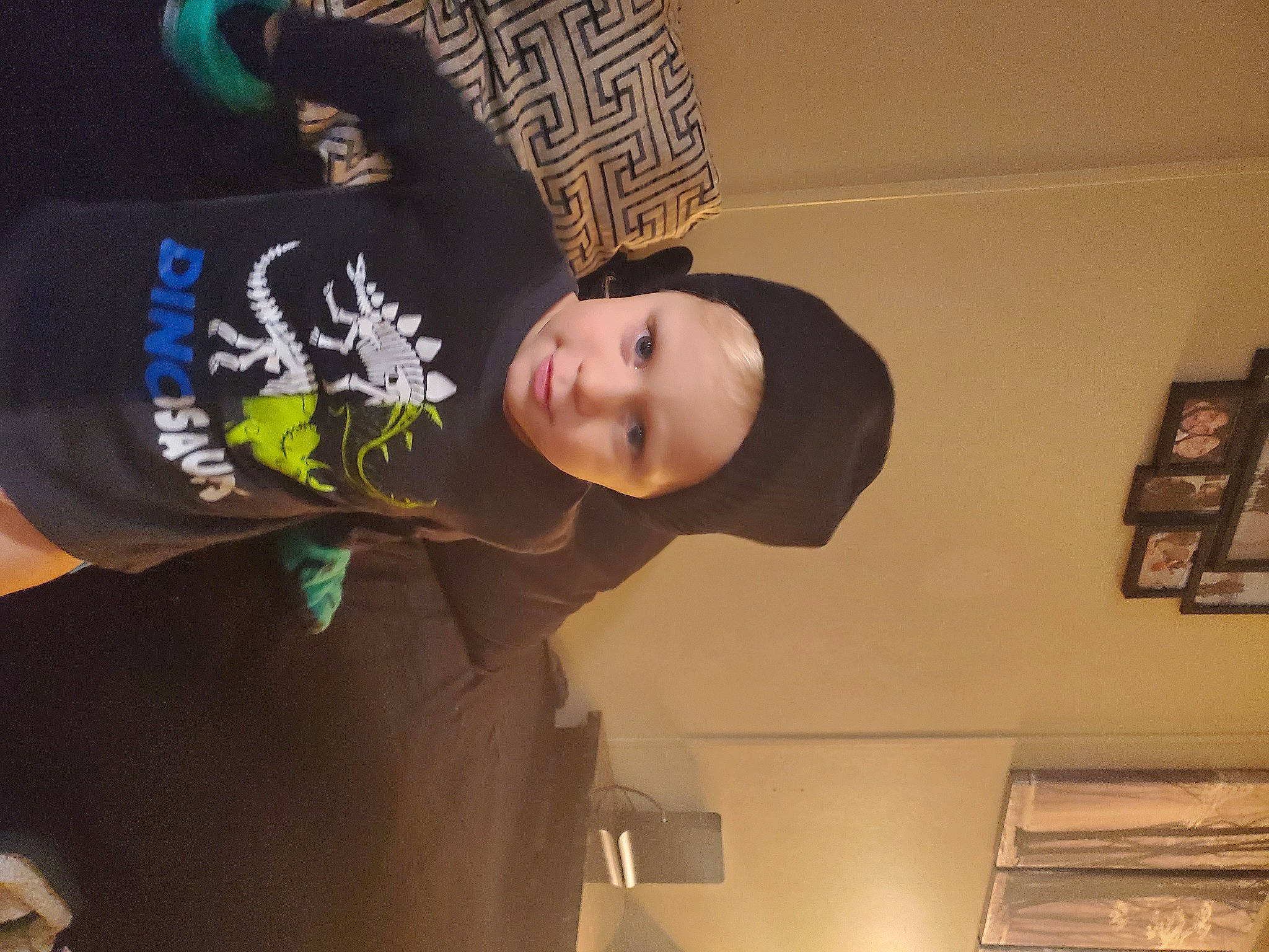 Alekzander is registered to the contest to win money with this photo: child, elbow, fun, headgear, headwear, person, picture_frame, room, sleeve, t_shirt