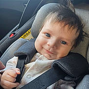 Lyla joined the competition — help win amazing prizes! baby, car_seat, child, smiling, blue_eyes, hair, seatbelt, clothing, infant, face, hand, straps, happy, portrait, car_interior, safety, cute, young_child, seat, closeup