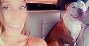 Malabu is registered to the contest to win money with this photo: animal, blonde_hair, car_interior, casual, companion, daylight, dog, friendship, happy, leather_seat, pet, portrait, seatbelt, selfie, smiling, summer, tank_top, tongue_out, transportation, woman