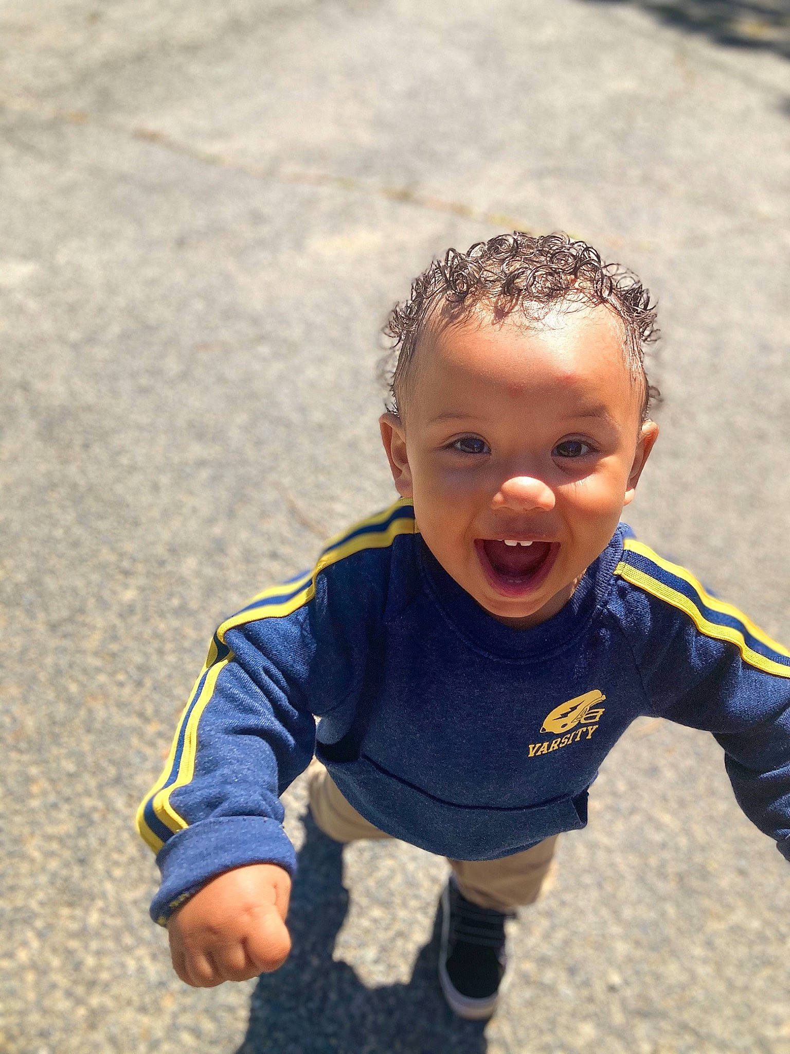 Brandon Jr is registered to the contest to win money with this photo: asphalt, baby, baby_toddler_clothing, child, flooring, fun, grass, happy, laugh, leisure, people_in_nature, person, play, recreation, sand, sitting, sleeve, smile, soil, t_shirt