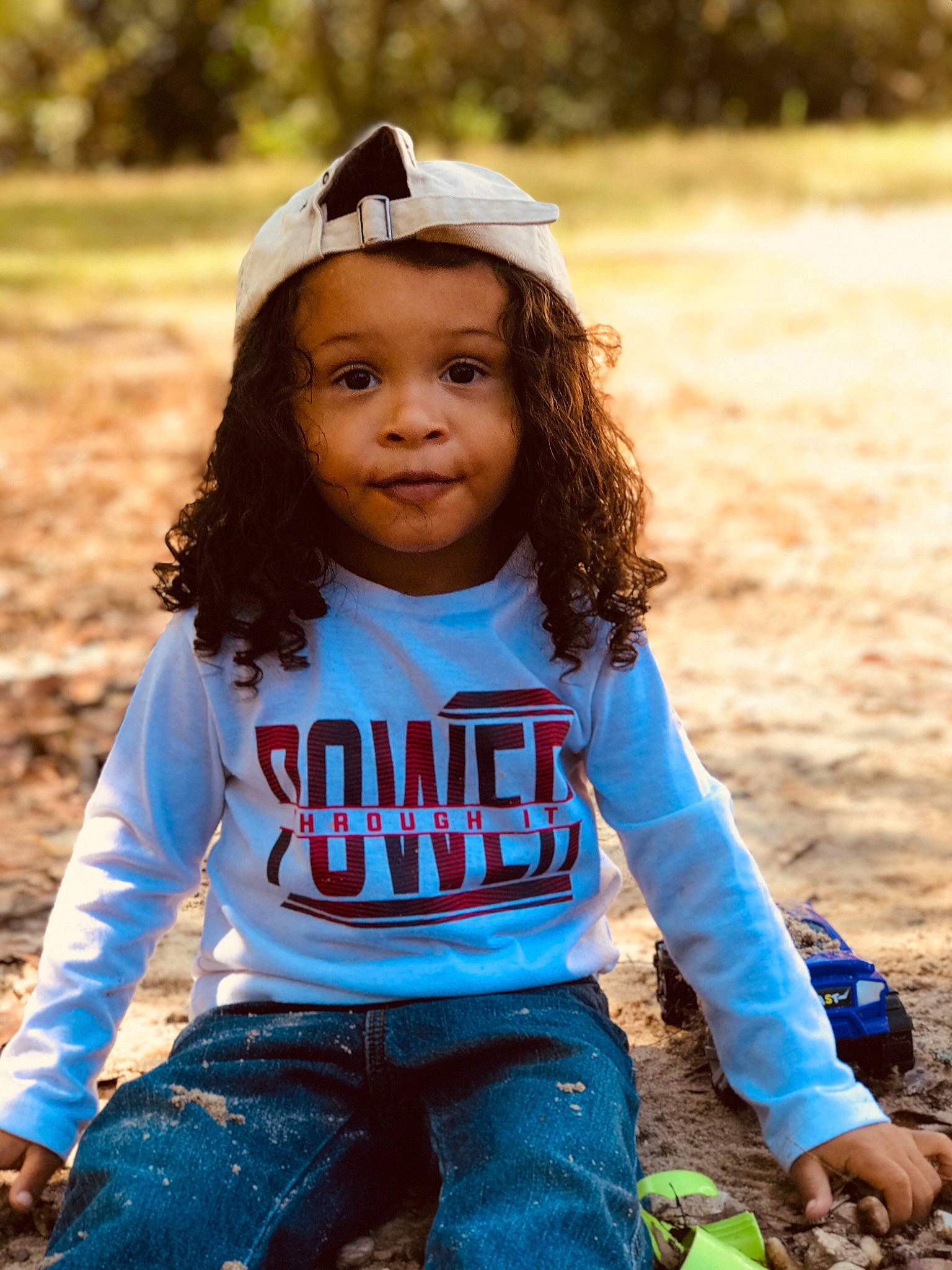 Elijah joined the competition — help win amazing prizes! beauty, child, child_model, fun, grass, happy, jeans, long_hair, outerwear, person, photo_shoot, photography, play, sitting, sleeve, smile, t_shirt, toddler