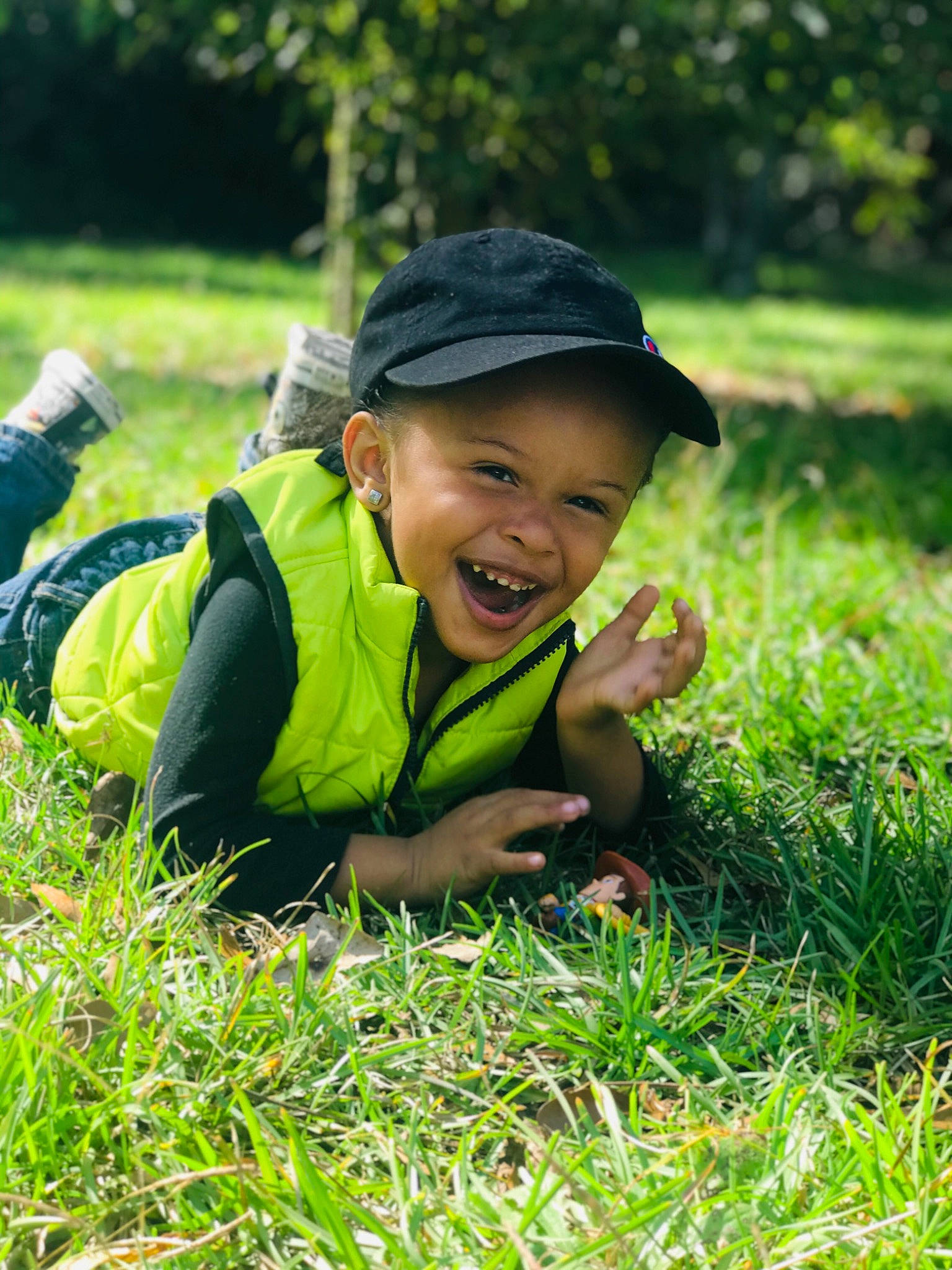 Elijah is registered to the contest to win money with this photo: adaptation, child, facial_expression, farm, grass, grass_family, grassland, green, happy, joy, lawn, people_in_nature, person, plant, play, smile, toddler