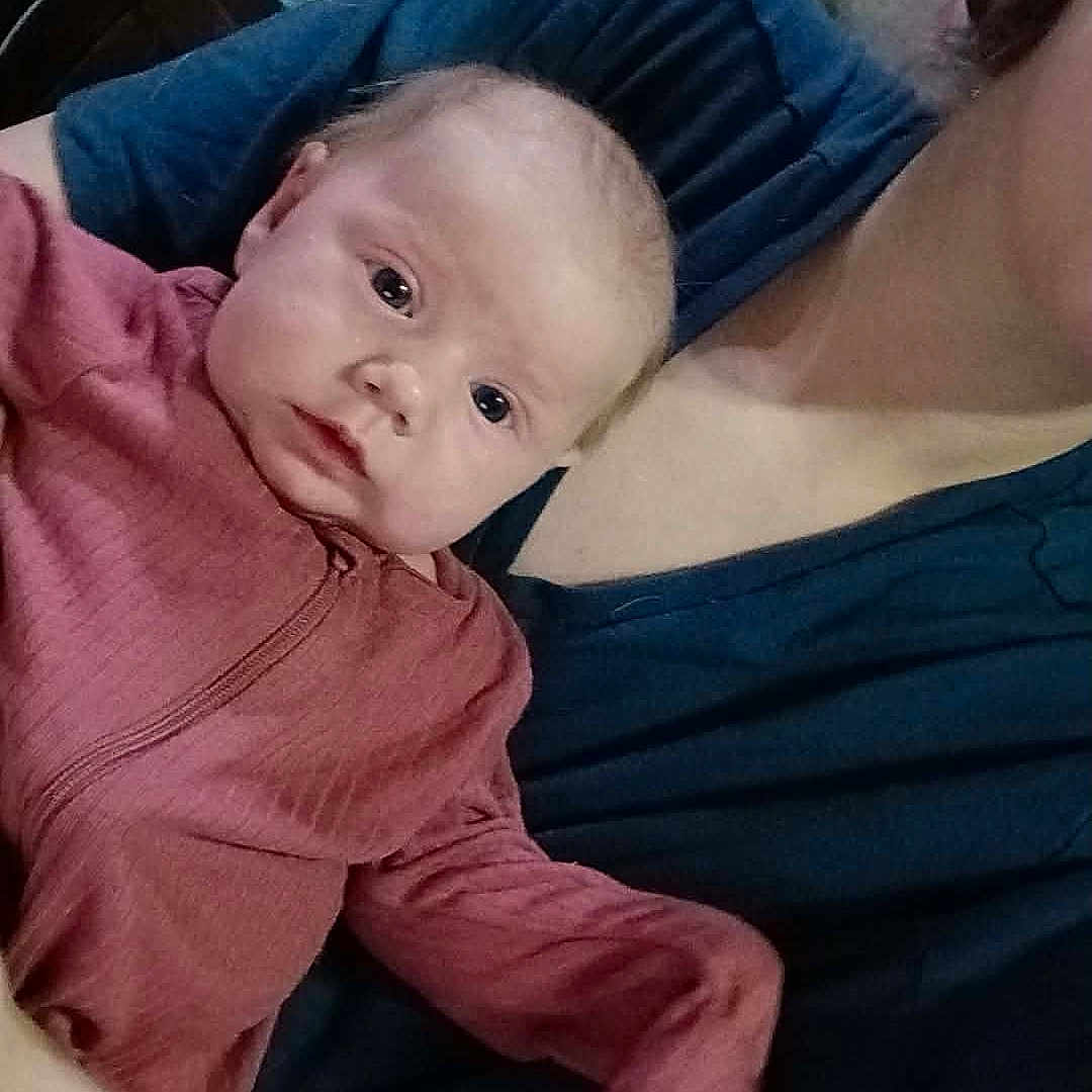 Lenora joined the competition — help win amazing prizes! adult, baby, casual, clothing, curious, face, fan, furniture, head, holding, home, human, indoor, infant, person, pink_outfit, portrait, room, shelf, toddler