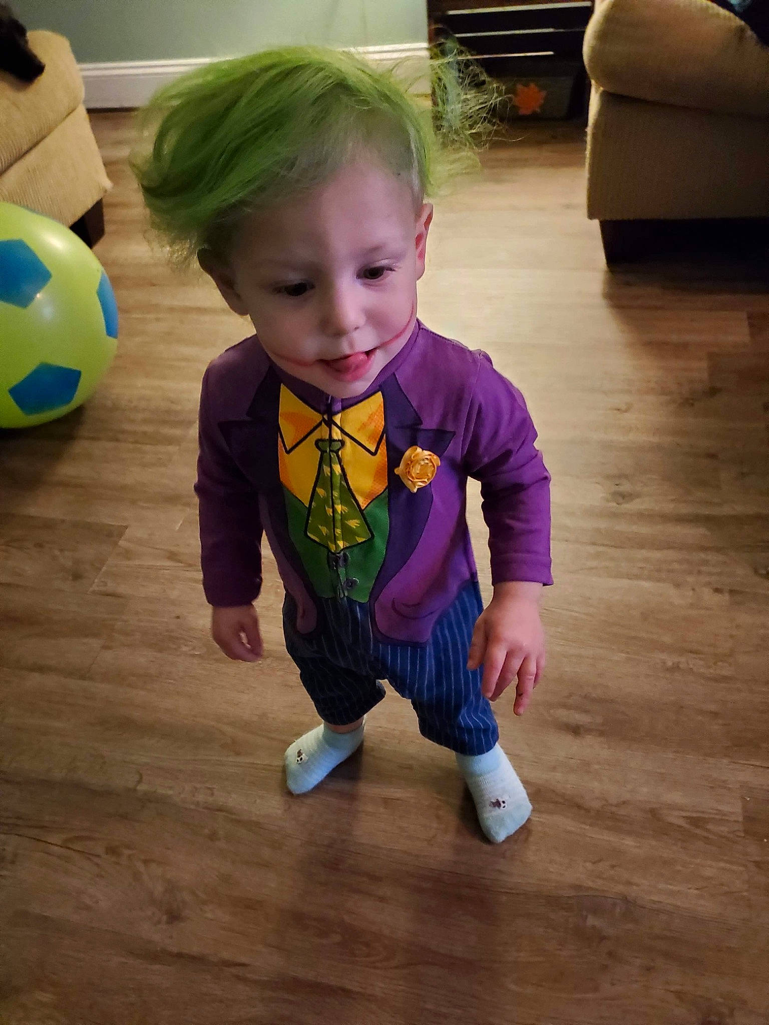 Bryson is registered to the contest to win money with this photo: baby_toddler_clothing, ball, child, cool, couch, floor, flooring, football, hardwood, home, laminate_flooring, living_room, nose, person, soccer_ball, sports_equipment, toddler, toy, wood, wood_flooring