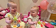 Esme And Lola is registered to the contest to win money with this photo: baby, balloons, birthday, carpet, celebration, child, crown_balloon, doll, gift_wrap, happy, indoor, number_one_balloon, onesie, pink, playful, present, purple, sitting, smiling, toys