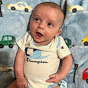 Dallas joined the competition — help win amazing prizes! baby, child, infant, onesie, blanket, blue, car_pattern, smiling, happy, face, expression, clothing, cute, portrait, laying_down, indoor, people, skin, head, hand