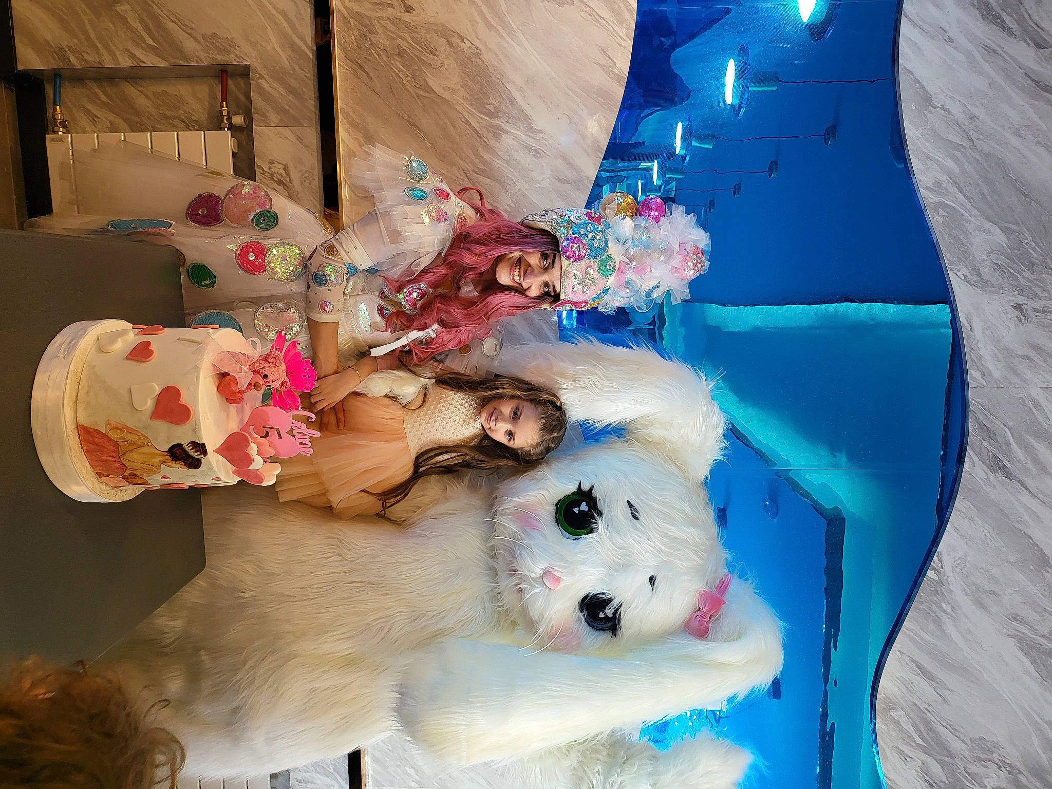 Celine a rejoint le concours — aidez-le/la à gagner de superbes lots ! art, child, companion_dog, costume, dress, event, fun, fur, happy, headwear, joy, person, pink, plush, room, smile, snapshot, stuffed_toy, toy, visual_arts