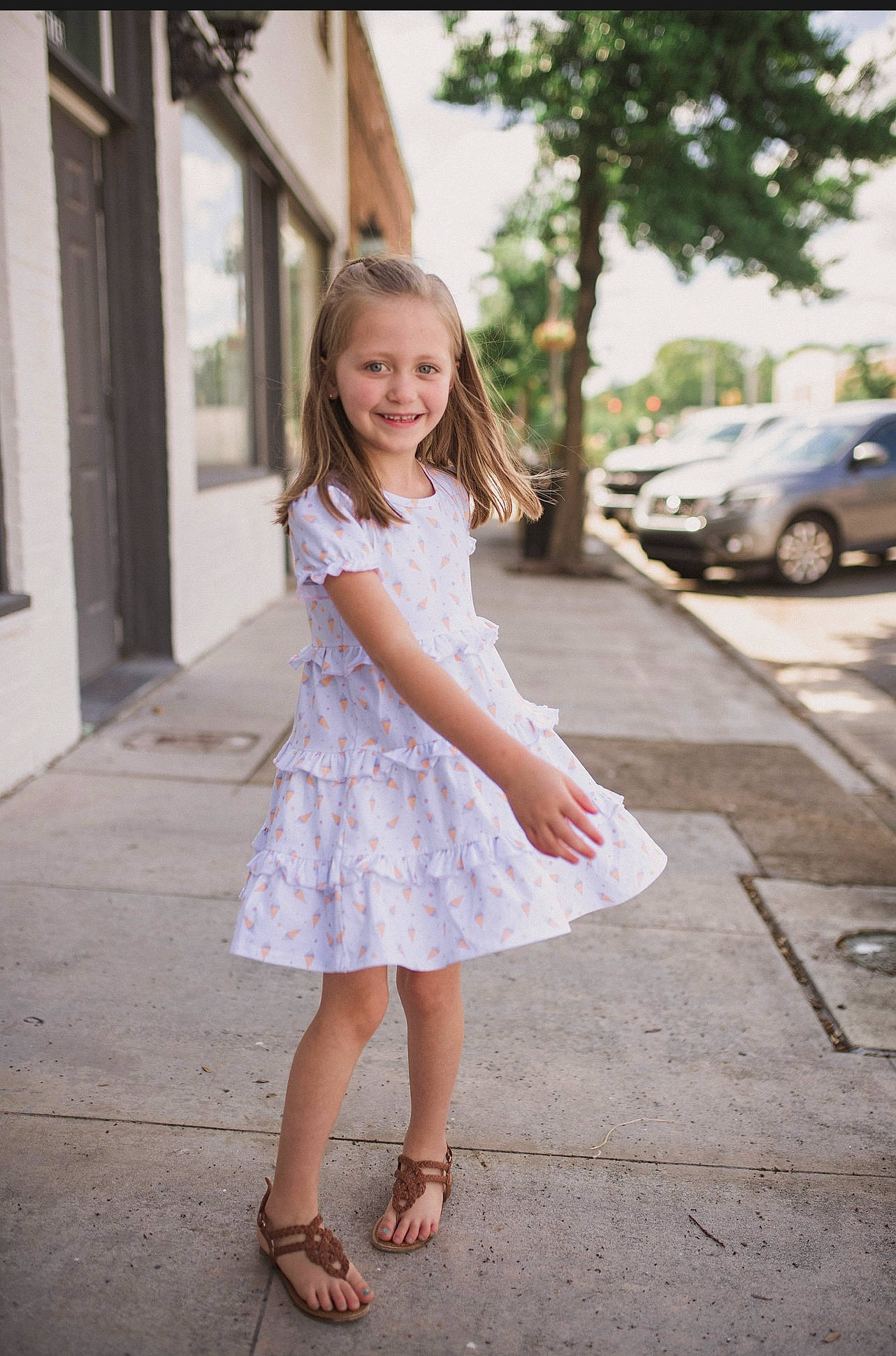 Madison joined the competition — help win amazing prizes! asphalt, car, day_dress, dress, flash_photography, happy, joy, long_hair, one_piece_garment, person, plant, sandal, skin, smile, standing, street_fashion, summer, tire, toddler, tree