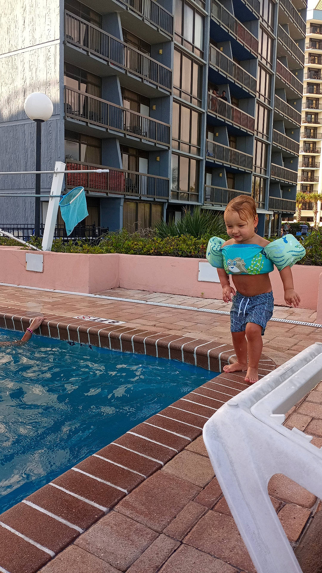 Greyson joined the competition — help win amazing prizes! architecture, azure, building, condominium, daytime, electric_blue, flooring, fun, joy, leisure, outdoor_furniture, person, plant, property, public_space, real_estate, recreation, shorts, swimming_pool, thigh