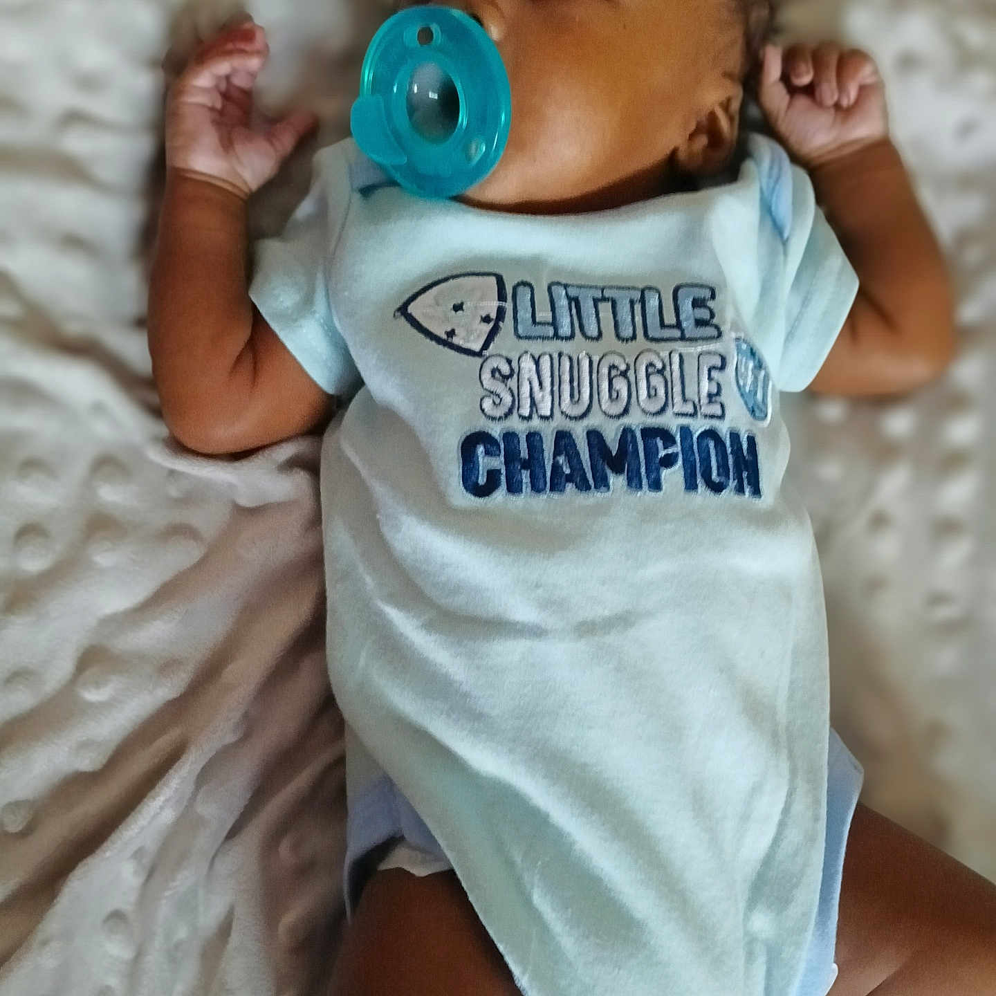 K'Rson is registered to the contest to win money with this photo: baby, blanket, child, clothing, comfortable, cute, face, hand, head, indoors, infant, lying_down, newborn, onesie, pacifier, skin, sleepwear, snuggle, soft_texture, toddler