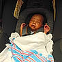 K'Rson joined the competition — help win amazing prizes! newborn, baby, sleeping, car_seat, blanket, striped_blanket, infant, child, seatbelt, warning_label, safety, resting, indoors, person, closeup, head, hands, comfort, swaddled, peaceful