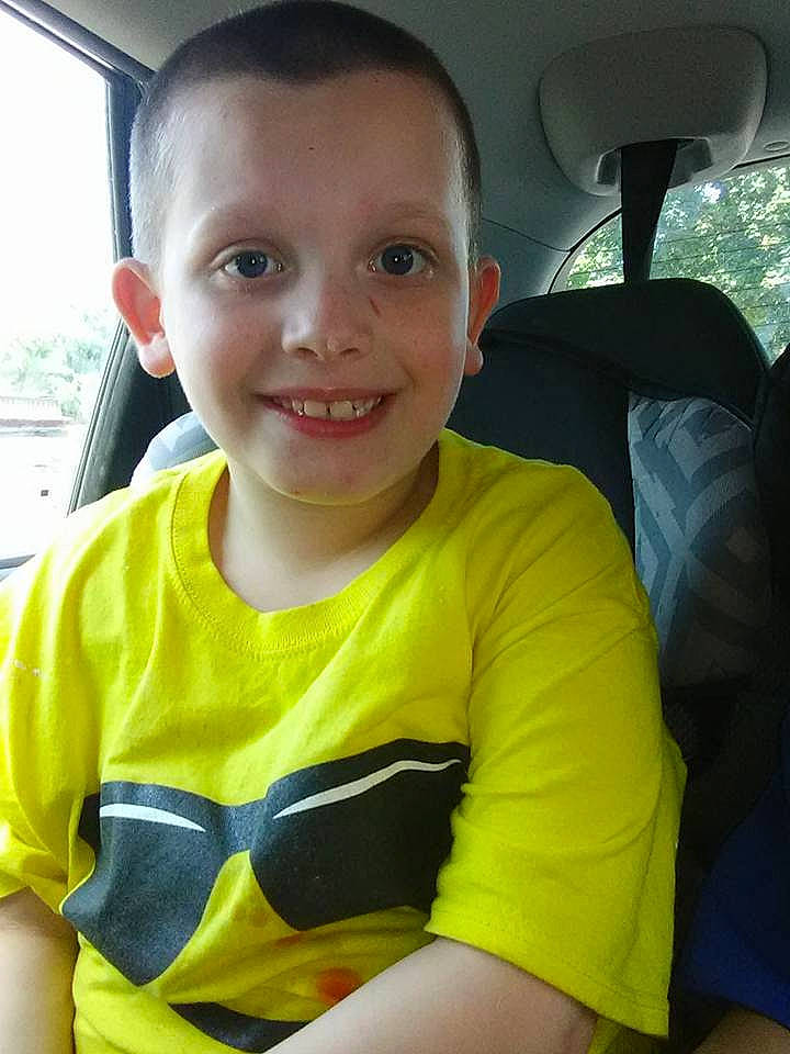 John is registered to the contest to win money with this photo: car, car_seat, child, face, happy, joy, person, personal_protective_equipment, skin, smile, toddler, vacation, yellow