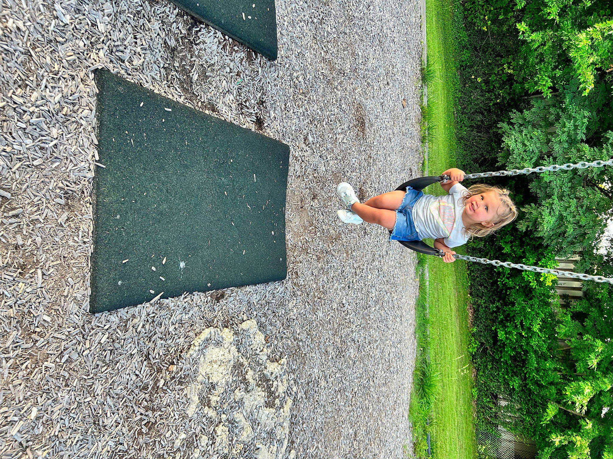 Mariana is registered to the contest to win money with this photo: asphalt, concrete, flooring, fun, grass, green, landscape, leaf, leisure, people_in_nature, person, plant, recreation, road_surface, shadow, shrub, sidewalk, soil, tar, toddler