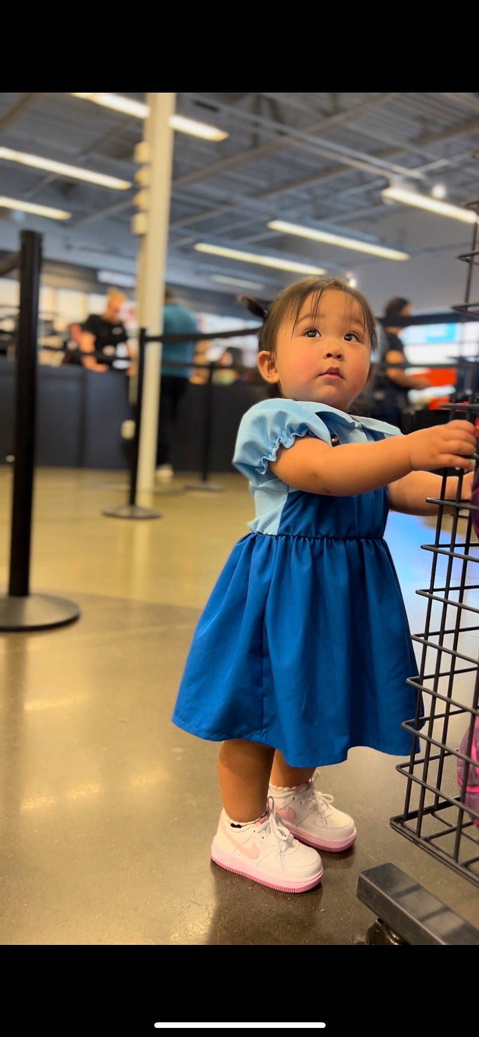 Amira is registered to the contest to win money with this photo: bag, child, electric_blue, event, flip_flops, flooring, fun, happy, human_leg, joint, leisure, person, room, sandal, shoe, shoulder, sitting, skin, sock, standing