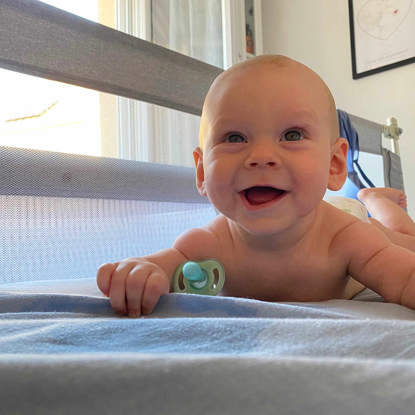 Gabriel participe au concours pour gagner de l'argent avec cette photo : baby, bed, blanket, child, crawling, cute, expression, face, foot, hand, happy, indoor, infant, natural_light, pacifier, portrait, room, skin, smile, window