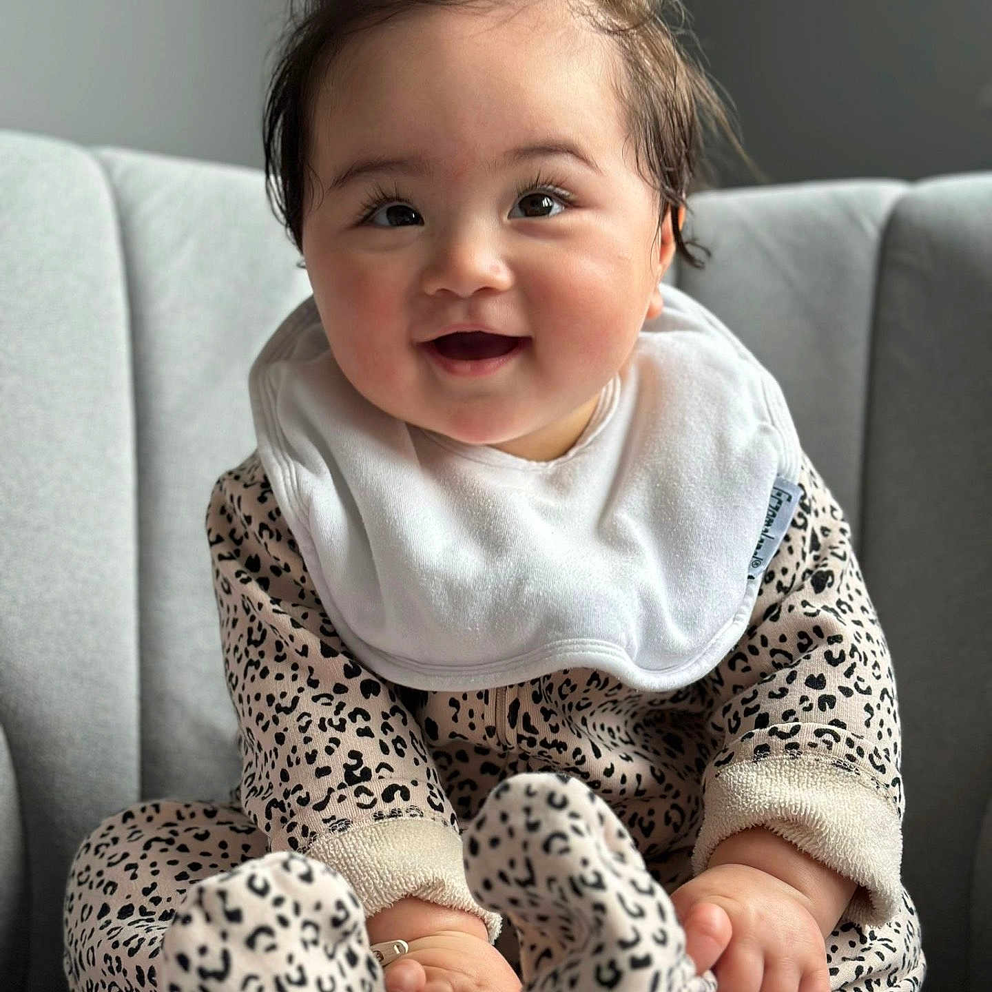 Aria joined the competition — help win amazing prizes! baby, babylaughing, clothing, couch, face, furniture, happy, head, hosiery, laughing, pants, person, photography, portrait, sitting, sleeve, smile, sock
