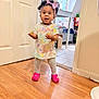 Aubree joined the competition — help win amazing prizes! child, toddler, indoor, wooden_floor, pink_shoes, colorful_dress, grapes, headband, curly_hair, expression, door, table, chair, kitchen, floor_tile, bracelet, person, home, standing, happy