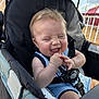 Maverick joined the competition — help win amazing prizes! baby, stroller, child, happy, smiling, outdoor, sunlight, fence, canopy, seatbelt, clothing, infant, laughing, face, person, hands, joy, cute, summer, fun