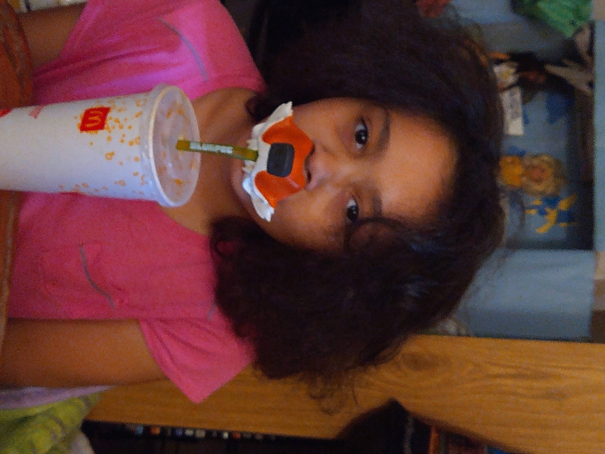 Kamilyah is registered to the contest to win money with this photo: baby, cap, cheek, child, drink, drinking, drinkware, eyelash, food, fun, lip, nail, nose, person, plastic_bottle, room, sweetness, table, toddler