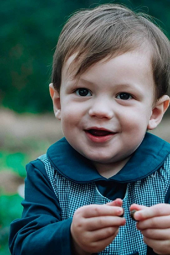 Lincoln joined the competition — help win amazing prizes! cheek, facial_expression, finger, flash_photography, fun, gesture, grass, happy, human, iris, joy, lip, nose, outerwear, person, plant, skin, sleeve, smile, standing