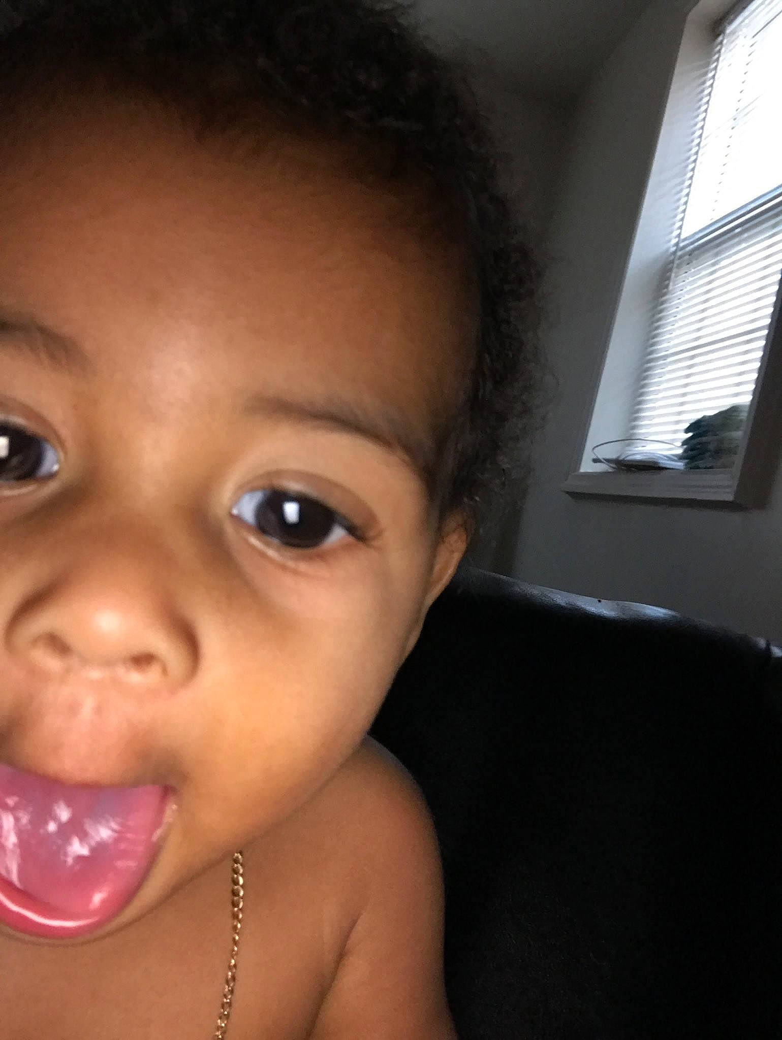 Eryn is registered to the contest to win money with this photo: black_hair, cheek, child, chin, close_up, ear, eyebrow, face, finger, forehead, girl, head, infant, lip, mouth, nose, person, skin, smile, toddler