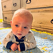 Lachlan joined the competition — help win amazing prizes! baby, child, infant, quilt, blue, yellow, stars, moon, floor, wooden_dresser, furniture, face, eyes, clothing, long_sleeves, crawling, indoors, cute, portrait, curious