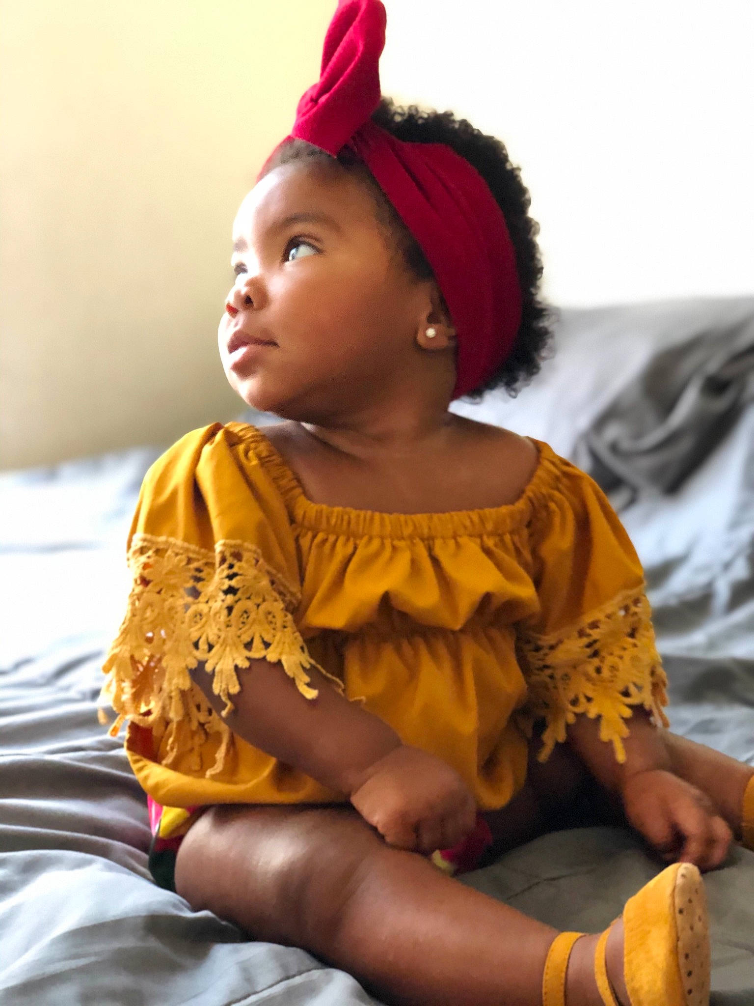 Amayah joined the competition — help win amazing prizes! baby, child, child_model, ear, eye, fashion_accessory, fawn, hair_accessory, headgear, people, person, photography, sitting, smile, toddler, tradition, yellow