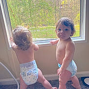 Chase joined the competition — help win amazing prizes! toddler, child, diaper, indoor, window, carpet, curly_hair, standing, baby, two_children, natural_light, looking_outside, barefoot, home, curiosity, candid, young_child, skin, person, daylight
